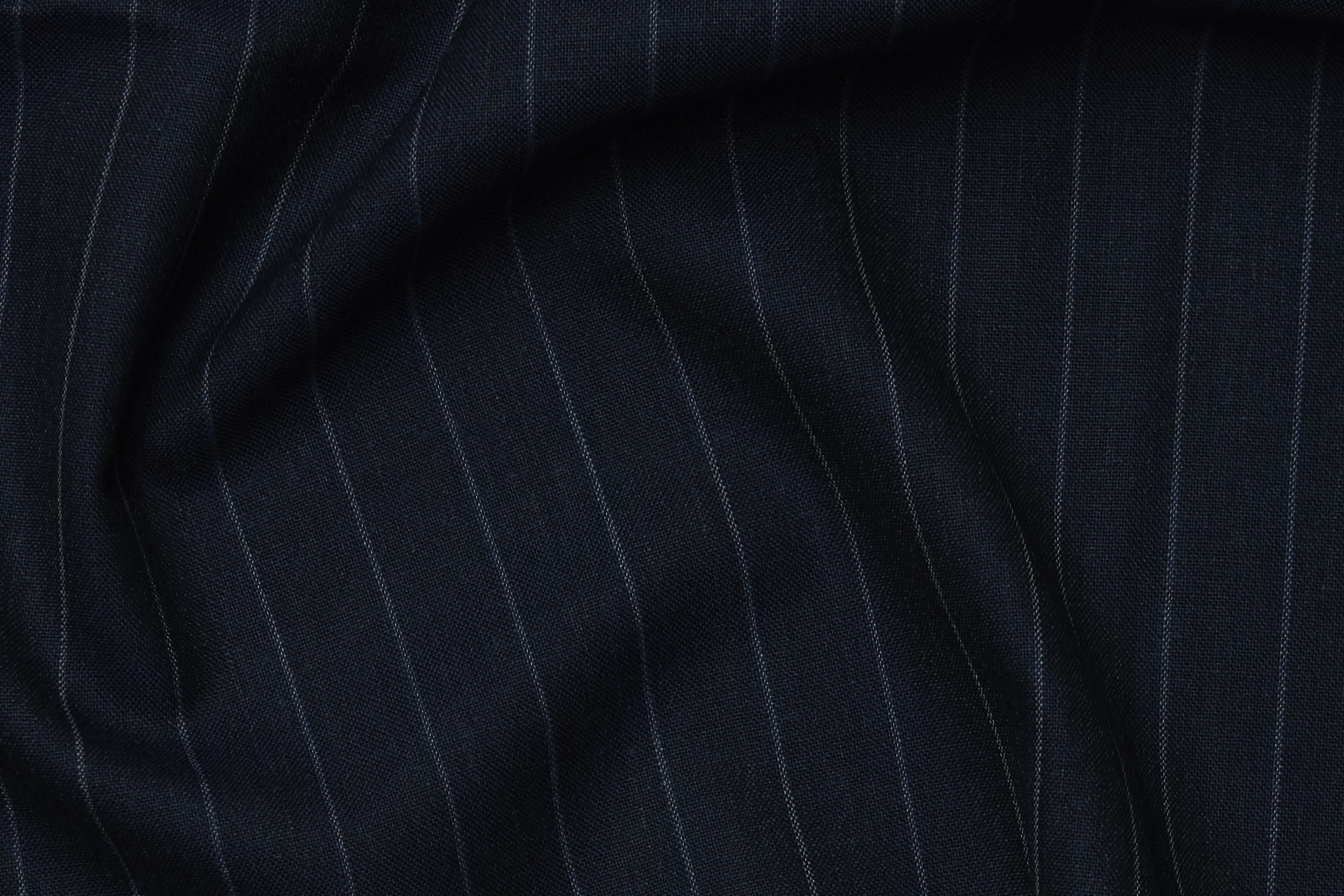 Armoury OP 2186 by Officine Paladino is a plain weave pencil stripe in indigo, made in England.