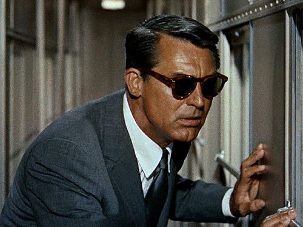 Cary Grant wearing a grey glen plaid suit