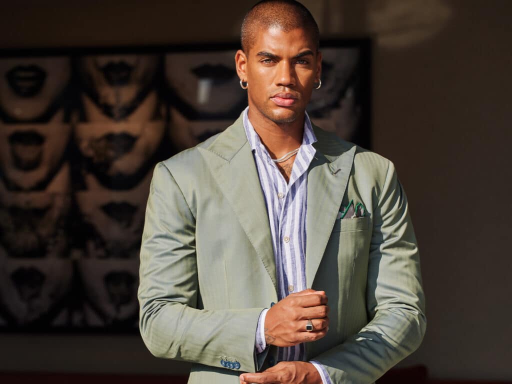 A model wears a Solaro suit made with OP2527 Langston with a casual striped shirt.