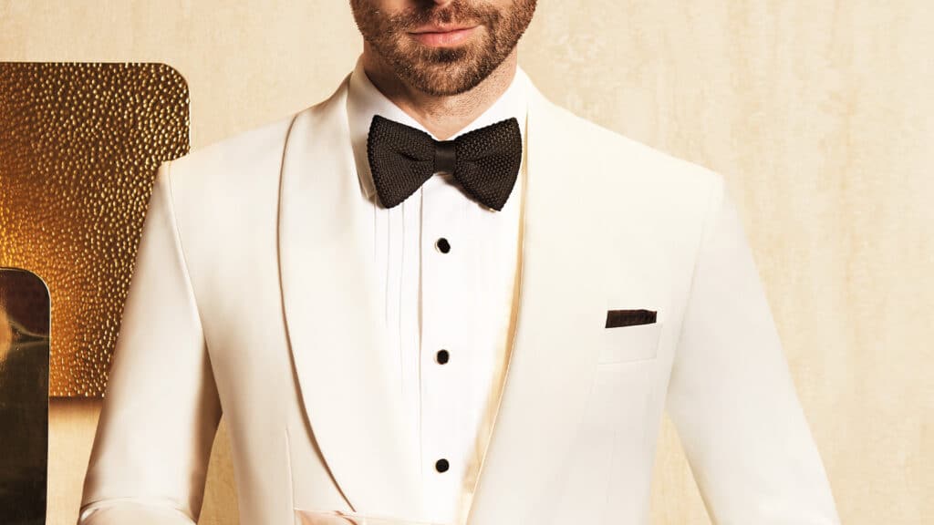 A well-fitted tuxedo jacket with shawl lapel in OP2050 Blanco, a faille-weave fabric meant for formalwear.