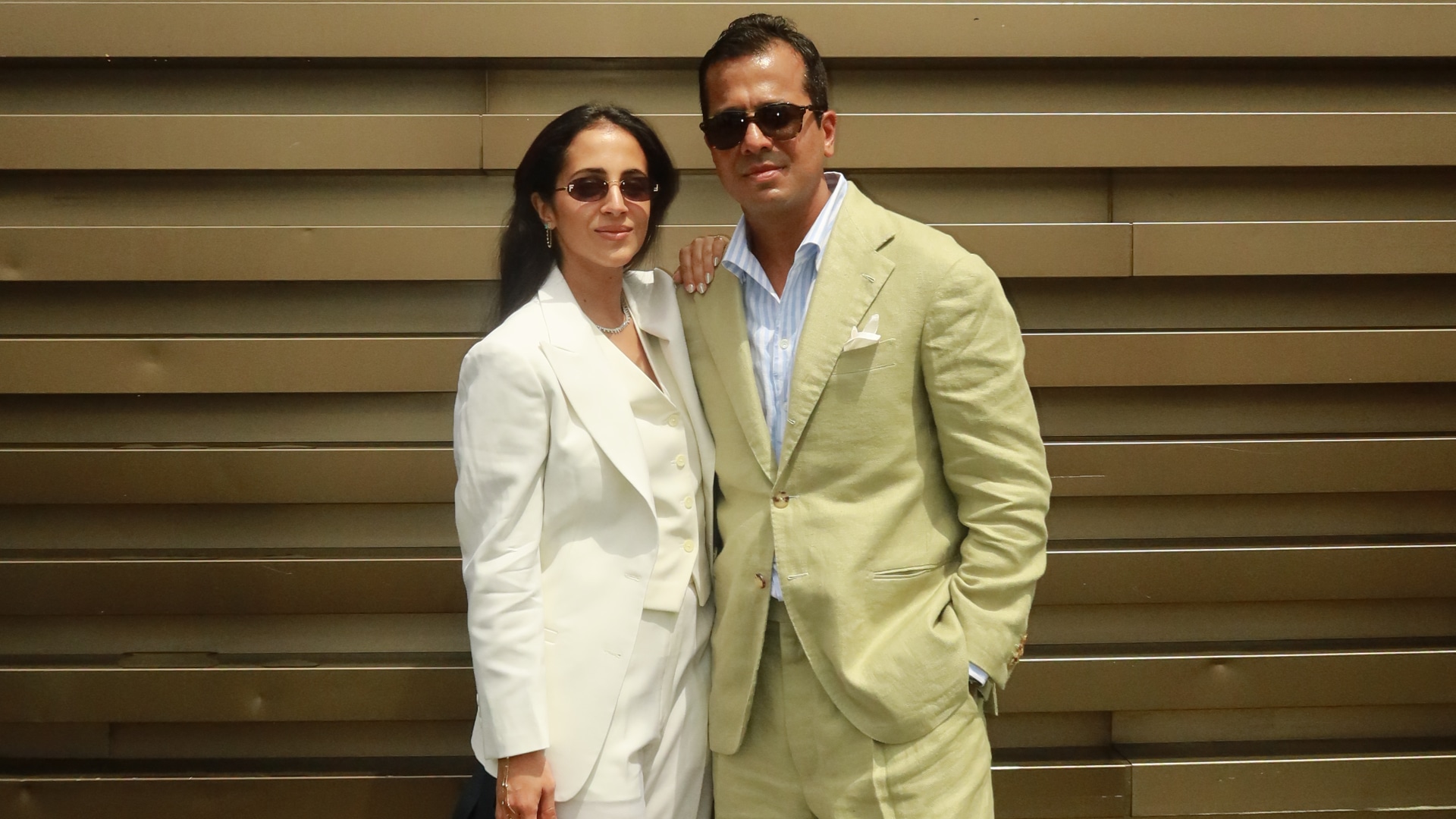 Two people wearing suits made with Officine Paladino fabrics. 