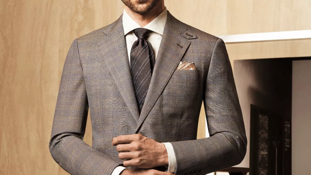 Man wearing a brown glen plaid suit.