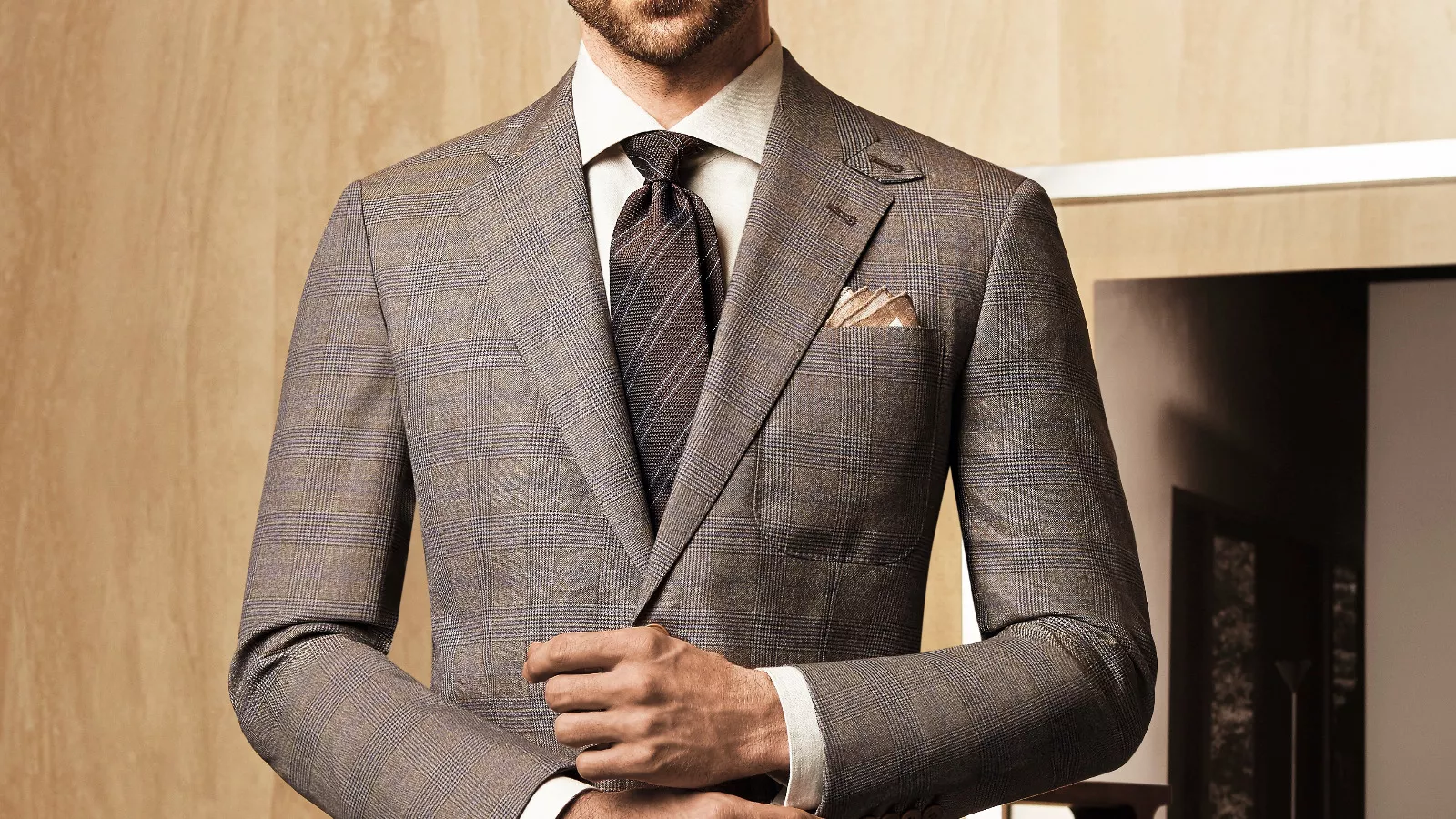 Man wearing a brown glen plaid suit.