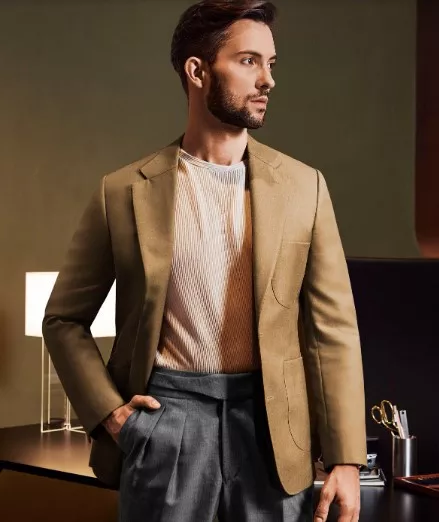 A man in a brown wool suit jacket with gray double-pleated pants