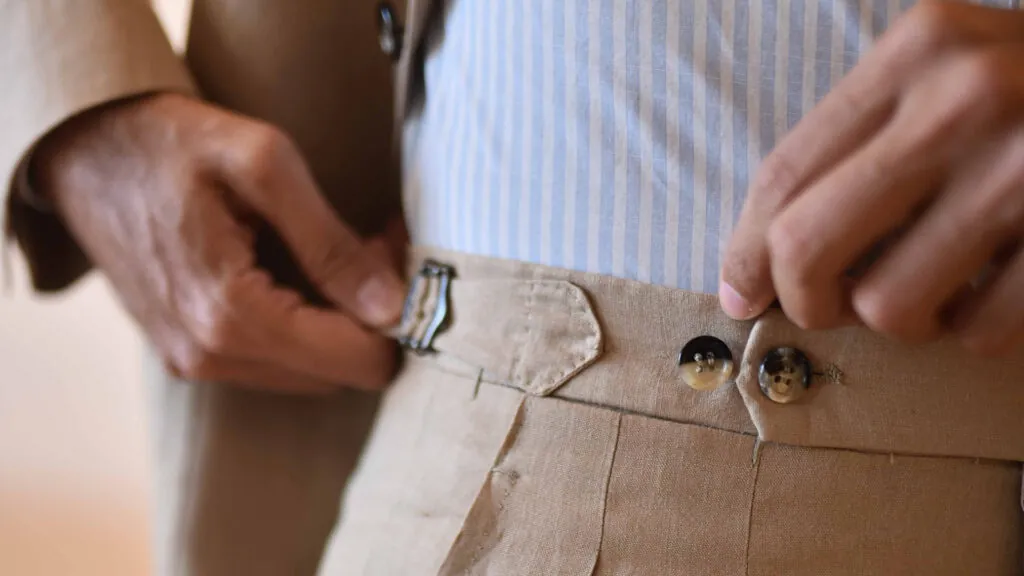 Details like side tabs, buttons, and even pant pleats, can give a linen suit a more formal look. Photo by Vincent Montuori.